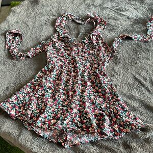 NWOT Romper sized L. Adjustable straps and tie back